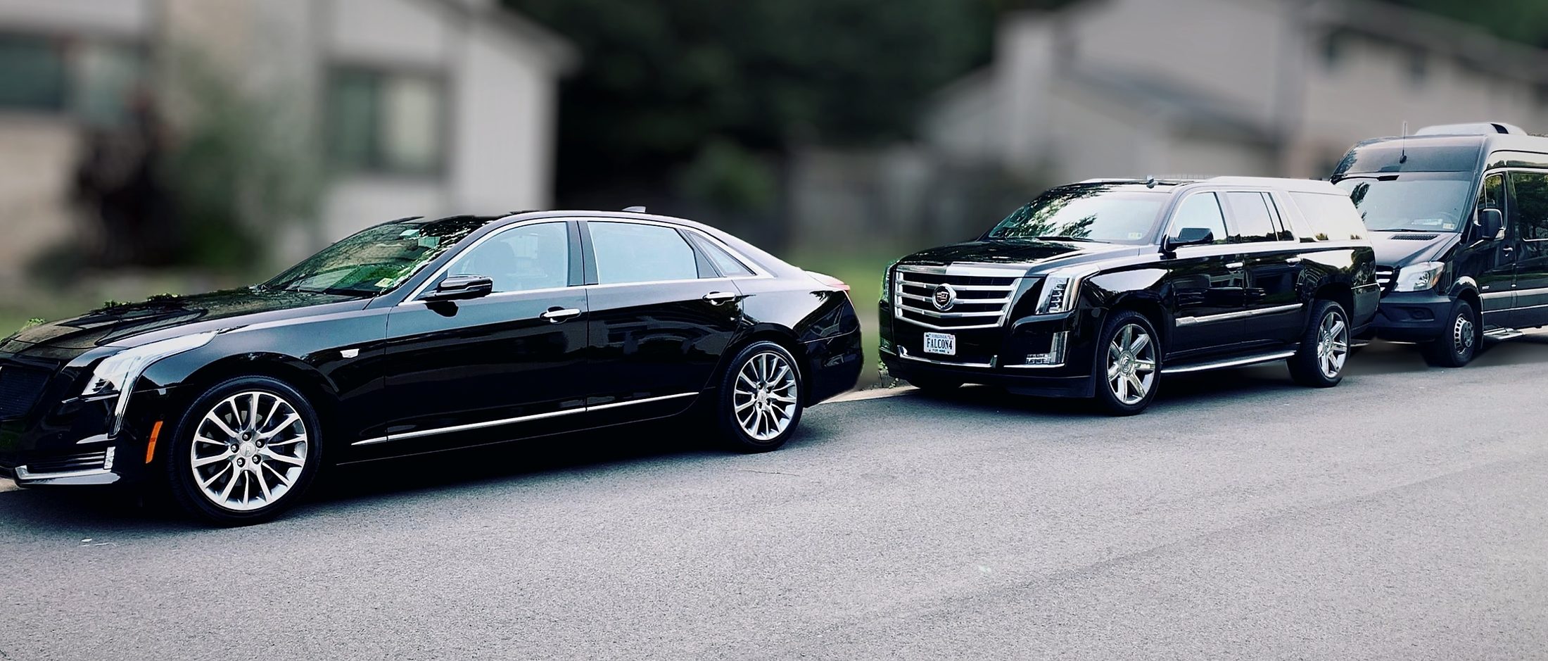 Falcon Valet Cadillac CT6 sedan, Cadillac Escalade SUV and Mercedes Sprinter parked in a row